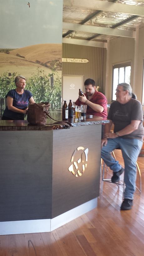 Visitors chatting across the tasting bar