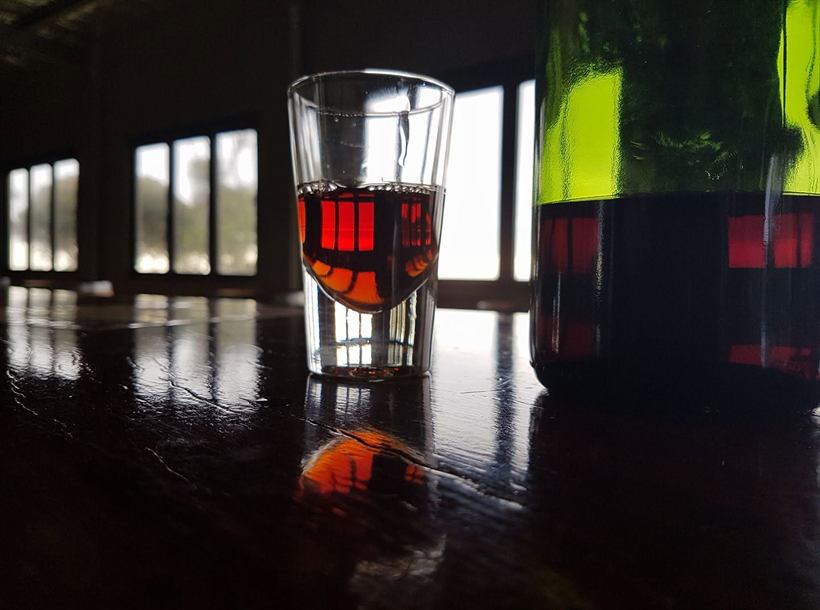A glass of port on the timber bar